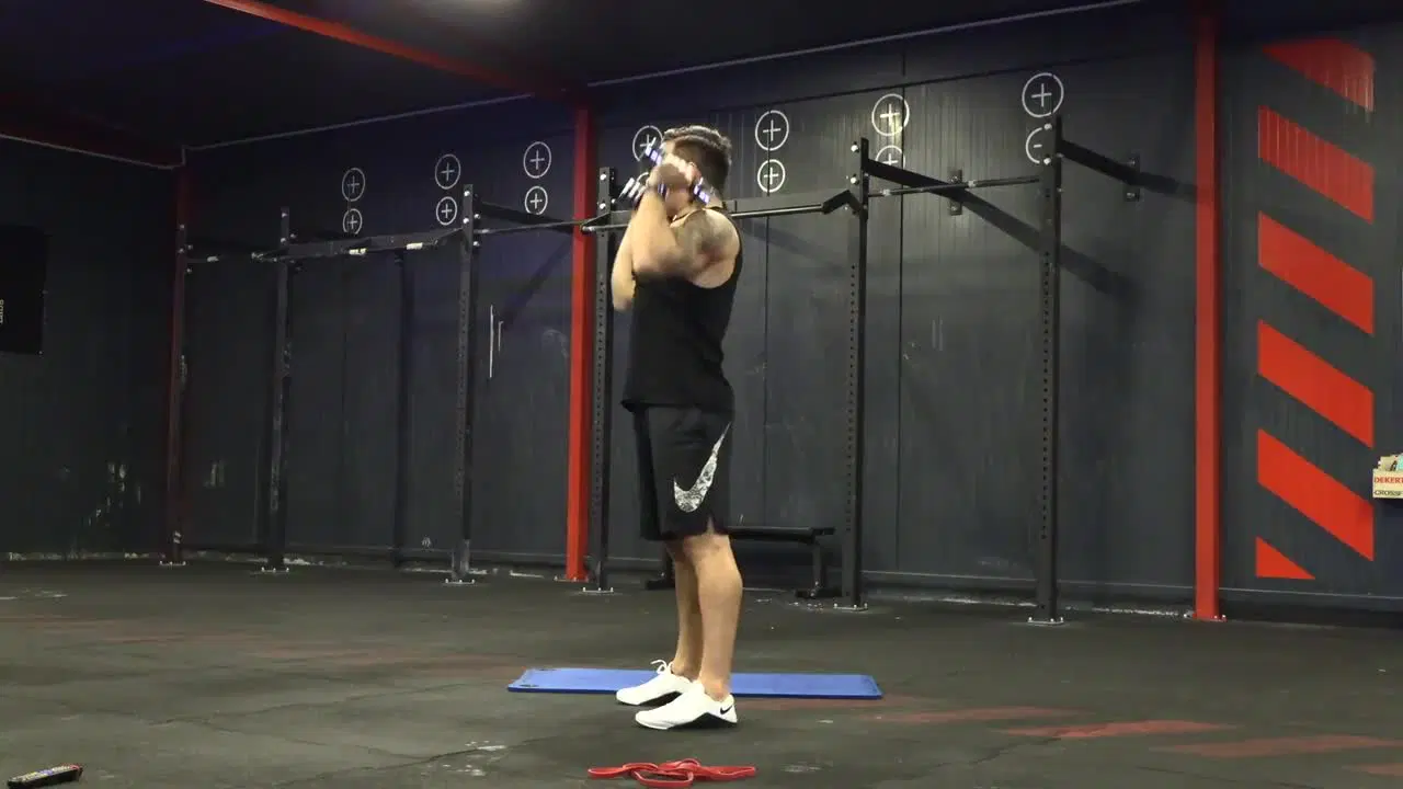 Kadr z treningu CrossFit w domu - siła i tempo z ciężarkami i gumą power band